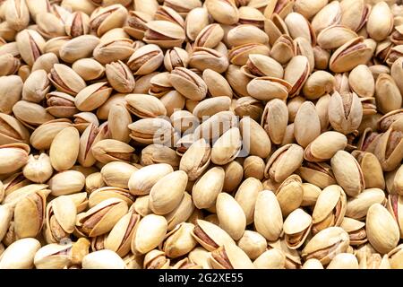 Pistachios texture and background . Tasty pistachios as background,as pistachios texture. Selective focus. Stock Photo
