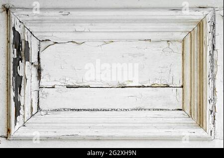Heavily cracked paint on a white wooden door panel Stock Photo