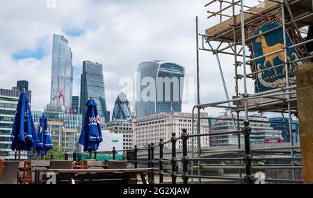 London. UK- 06.10.2021. A cityscape of the City of London with its skyscrapers with the crest of the museum ship Golden Hind in the foreground. Stock Photo