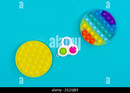 popit and simple dimple on a blue background. Antistress toy trend of 2021. Stock Photo