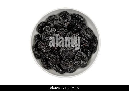Prunes in a bowl on a white background. dry plums Stock Photo