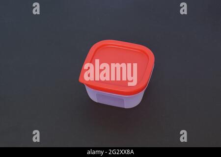 Square Plastic container in a dark background Stock Photo