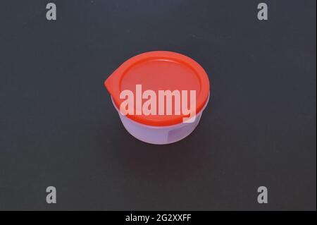 Round Plastic container in a dark background Stock Photo