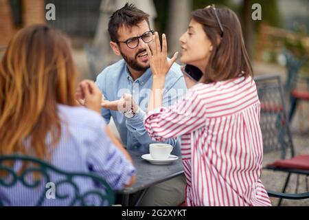 Three students drinking coffee together in the morning Stock Photo