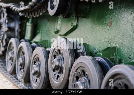 Fragment of a tracked track on a green camouflage tank. Stock Photo