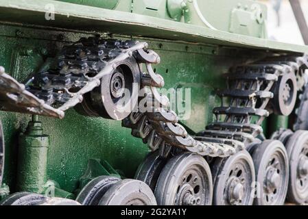 Fragment of a tracked track on a green camouflage tank. Stock Photo