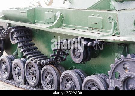 Fragment of a tracked track on a green camouflage tank. Stock Photo