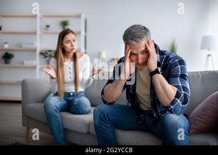 Frustrated mature lady shouting at her marriage partner, having argument at home, free space Stock Photo
