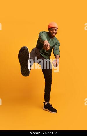 Gotcha. Handsome black smiling hipster guy pointing fingers at camera Stock Photo