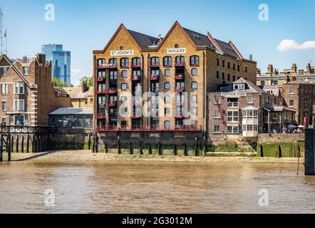 St John's Wharf Converted Warehouse apartment Block and The Captain Kidd Pub from the River Thames, London, UK Stock Photo