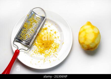 Grater and lemon zest isolated on white background. Directly above. Stock Photo