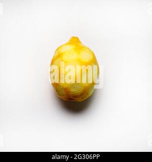 One lemon with peel grated isolated on white background. Directly above. Stock Photo