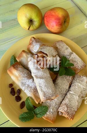 Apple mini strudel with puff pastry on a yellow plate. Directly above. Stock Photo