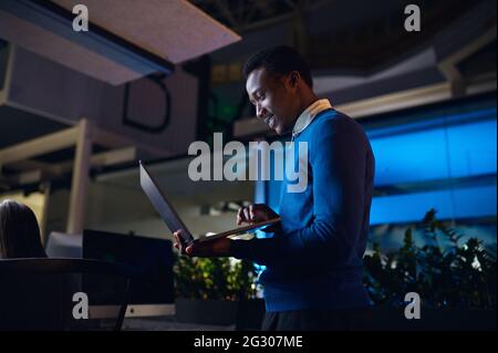 One manager works on laptop in night office Stock Photo