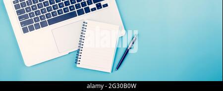 Flat lay of Laptop computer and plant and pen on desk in office, workplace and notebook and potted tree and book, workspace and copy space, top view, Stock Photo