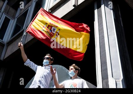 Madrid, Spain. 13th June, 2021. A protester holds a flag with his son during the protest. Thousands of people in Madrid are protesting the Spanish government's plan to issue pardons to separatist leaders who were convicted for their roles in the independence process of 2017. (Photo by Cristóbal Ospina/ SOPA Images/Sipa USA) Credit: Sipa USA/Alamy Live News Stock Photo