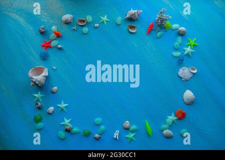 Seashells summer background. rectangular frame. Many different seashells, starfish on a background of blue shimmering strokes. Creative flat lay banne Stock Photo