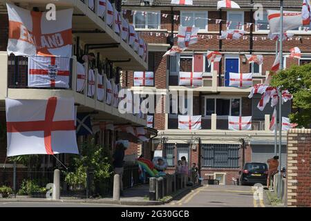 Bermondsey South East London, UK. 13th June, 2021. Patriotic Football supporters on the Kirby Estate in Bermondsey South East London prepare homes ready to support England in their first Euro 2020 match vs Croatia. Residents have decorated the estate with hundreds of flags of St George as they get behind their country for England's Wembley opener. Credit: MARTIN DALTON/Alamy Live News Stock Photo