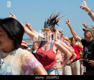 St Ives, Cornwall, UK. 13th June, 2021. Extinction Rebellion protesters participate in a 'disco-bedience' on the beach at St Ives, Cornwall, as part of their final action aginst the G7. 13th June 2021. Anna Hatfield/Pathos Credit: One Up Top Editorial Images/Alamy Live News Stock Photo