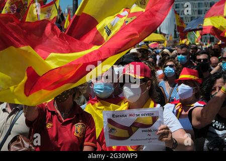 Madrid, Spain. 13th June, 2021. June 13, 2021, Madrid, Spain: A protester holds a flag and a banner which specifies to Stop the Spanish president during the protest.Thousands of people in Madrid are protesting the Spanish government's plan to issue pardons to separatist leaders who were convicted for their Credit: CORDON PRESS/Alamy Live News Stock Photo