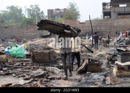 New Delhi, India. 13th June, 2021. Belongings of the Rohingya refugees are collected during the aftermath. A fire incident broke out at the Rohingya refugee camp leaving over 50 shanties of Rohingya refugees gutted. The cause of the fire has not yet been established. Credit: SOPA Images Limited/Alamy Live News Stock Photo