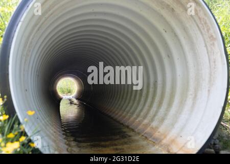 Perforated drainage pipe installed in rural area, look through the pipe ...