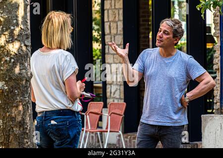 The owner of the Graace Hotel in Luxembourg talking to travel journalist Angela Berg Stock Photo