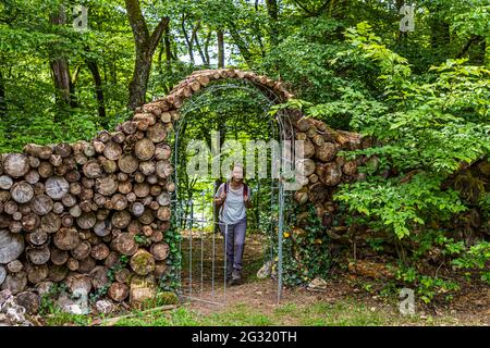 Garden entrance arch from small cut tree trunks in Lipperscheid, Luxembourg Stock Photo