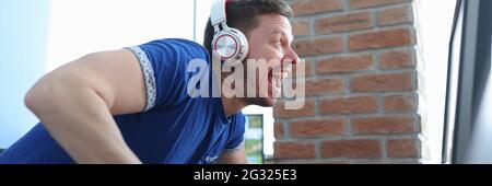 Young man with headphones playing computer game Stock Photo