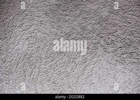 Roughly textured surface of a painted wall . Stock Photo