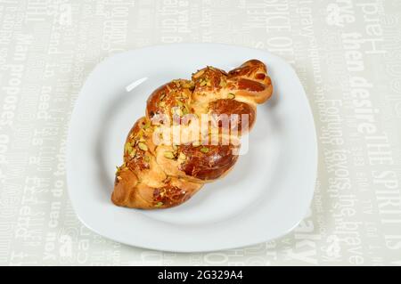 Fresh on a white plate paskalya coregi, challah, easter bun, isolated on white background Stock Photo
