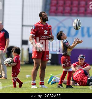 Llanelli, UK. 13th June, 2021. Uzair Cassiem of the Scarlets is interviewed after the game as his children play. Guinness Pro14 Rainbow Cup match, Scarlets v Edinburgh Rugby at the Parc y Scarlets Stadium in Llanelli, South Wales on Sunday 13th June 2021. pic by Andrew Orchard/Andrew Orchard sports photography/Alamy Live news Credit: Andrew Orchard sports photography/Alamy Live News Stock Photo