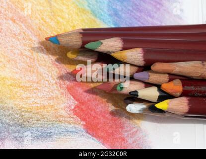 many multi-colored pencils for drawing on colored paper Stock Photo