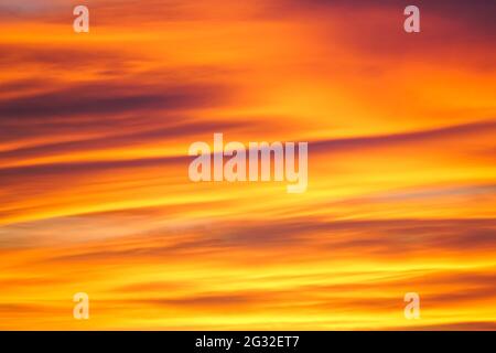 colorful cloudy fiery orange yellow sunset sky, beautiful background Stock Photo