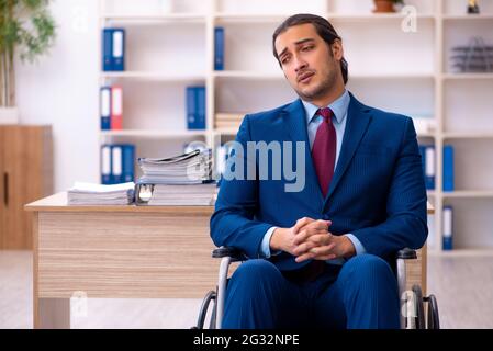 Young male disabled employee working in the office Stock Photo