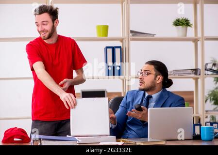 Man delivering pizza to the office Stock Photo