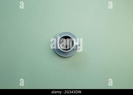 Cup of coffee on green background. top view, copy space Stock Photo