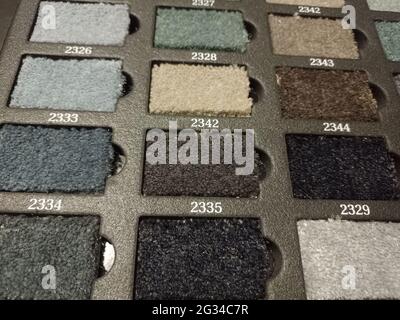 Sliced pieces of carpet. Samples of flooring. Home carpet. Examples of carpets in the catalog. Book with floor coverings. Stock Photo