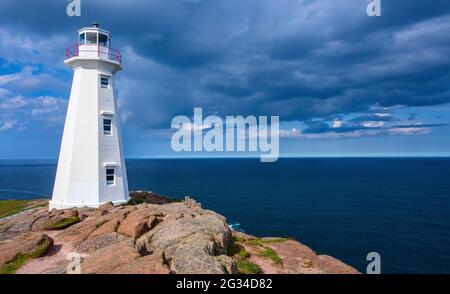 The Cape Spear Lighthouse in Newfoundland, under a dramatic blue cloud sky. Stock Photo