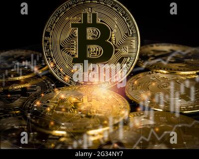 Bitcoin technology background. Golden bitcoin with chart and candlestick with network transfer on dark background, cryptocurrency investment concept. Stock Photo