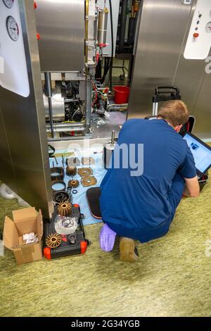 a technician repairs a defective steam sterilizer in a hospital Stock Photo