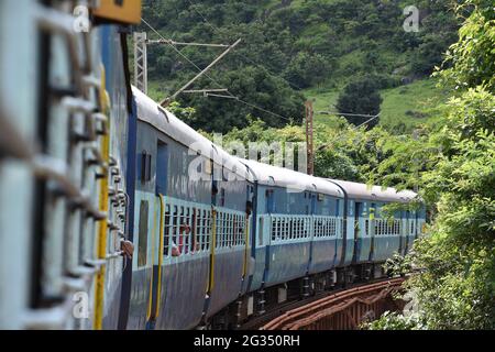 Indian Railways train Kirandul Passenger running through Araku Valley, Andhra Pradesh, India Stock Photo