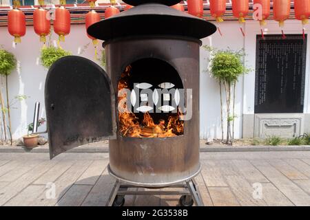 A closeup shot of pieces of wood burning inside old metal oven