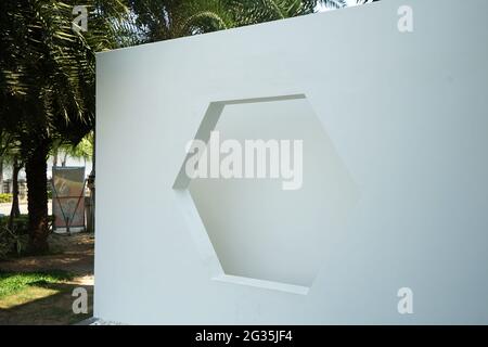 White Hexagon window shade on white concrete cement wall Stock Photo