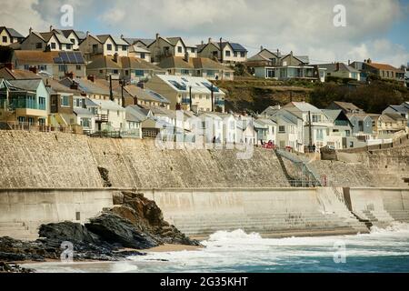 Cornish tourist destination Porthleven, Cornwall, England,  pictured housing stock along the coastal Cliff Road and the sea defence wall Stock Photo