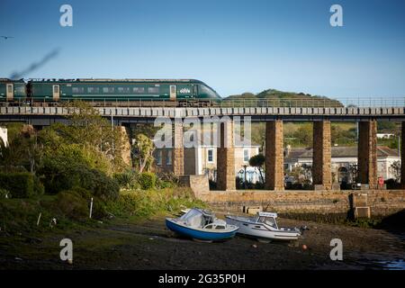 Hayle Viaduct  carrying the Hitachi GWR British Rail Class 800 Penzance to Paddington main line with boats in Copperhouse Pool Stock Photo