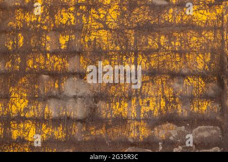 Old rusty vintage metal wall, grunge style scratched yellow weathered background. Stock Photo