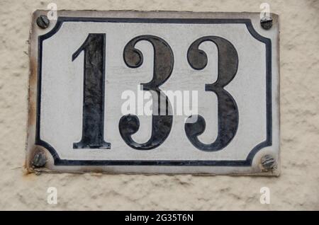 a sign with the house number 133 one hundred thirty three Stock Photo