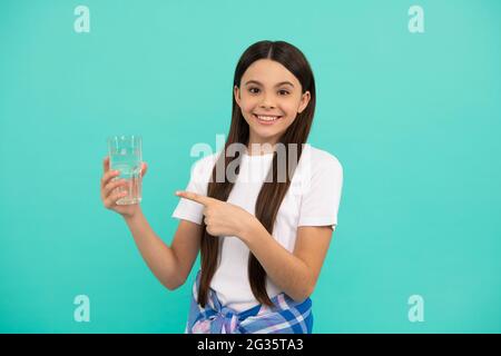 stay hydrated. kid hold glass of mineral water. child feel thirsty. Stock Photo