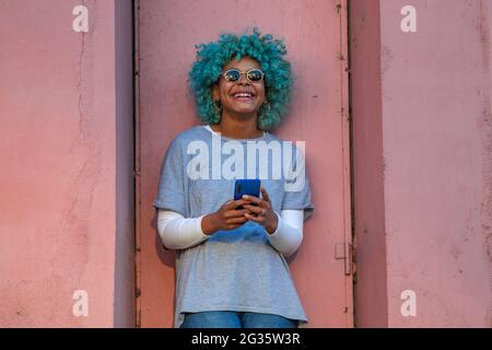 afro american hipster girl with mobile phone on the street Stock Photo